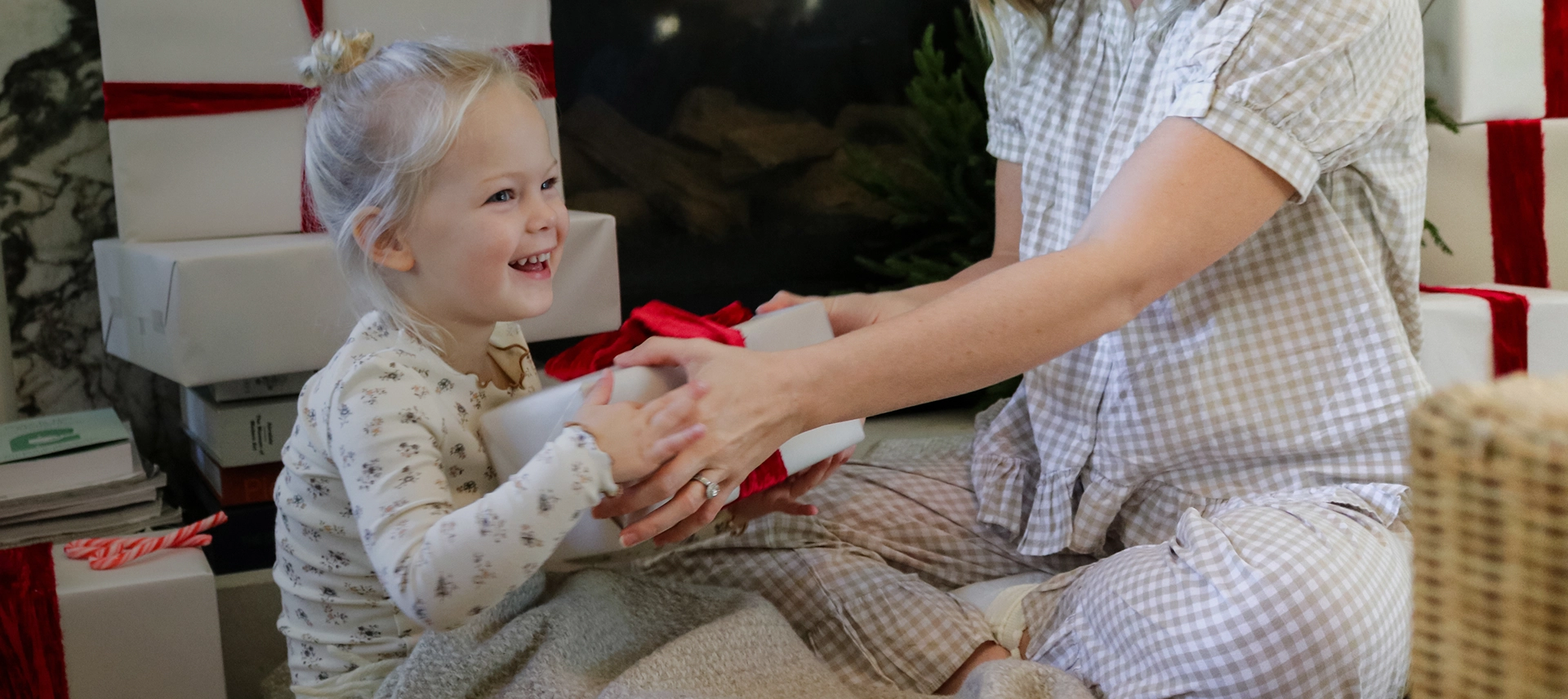 Truly Free Laundry Wash and refill pouch in a laundry room, with a woman and baby in the background.