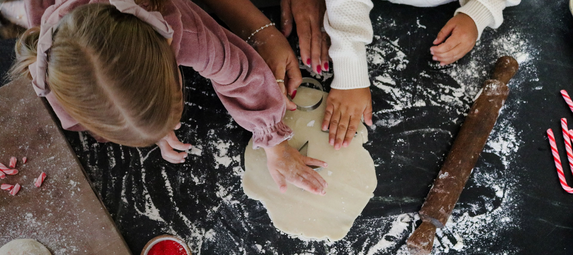 Truly Free Laundry Wash and refill pouch in a laundry room, with a woman and baby in the background.
