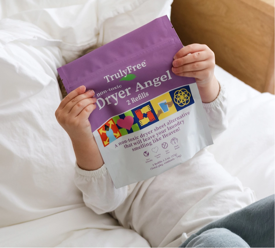 Truly Free Laundry Wash and refill pouch in a laundry room, with a woman and baby in the background.