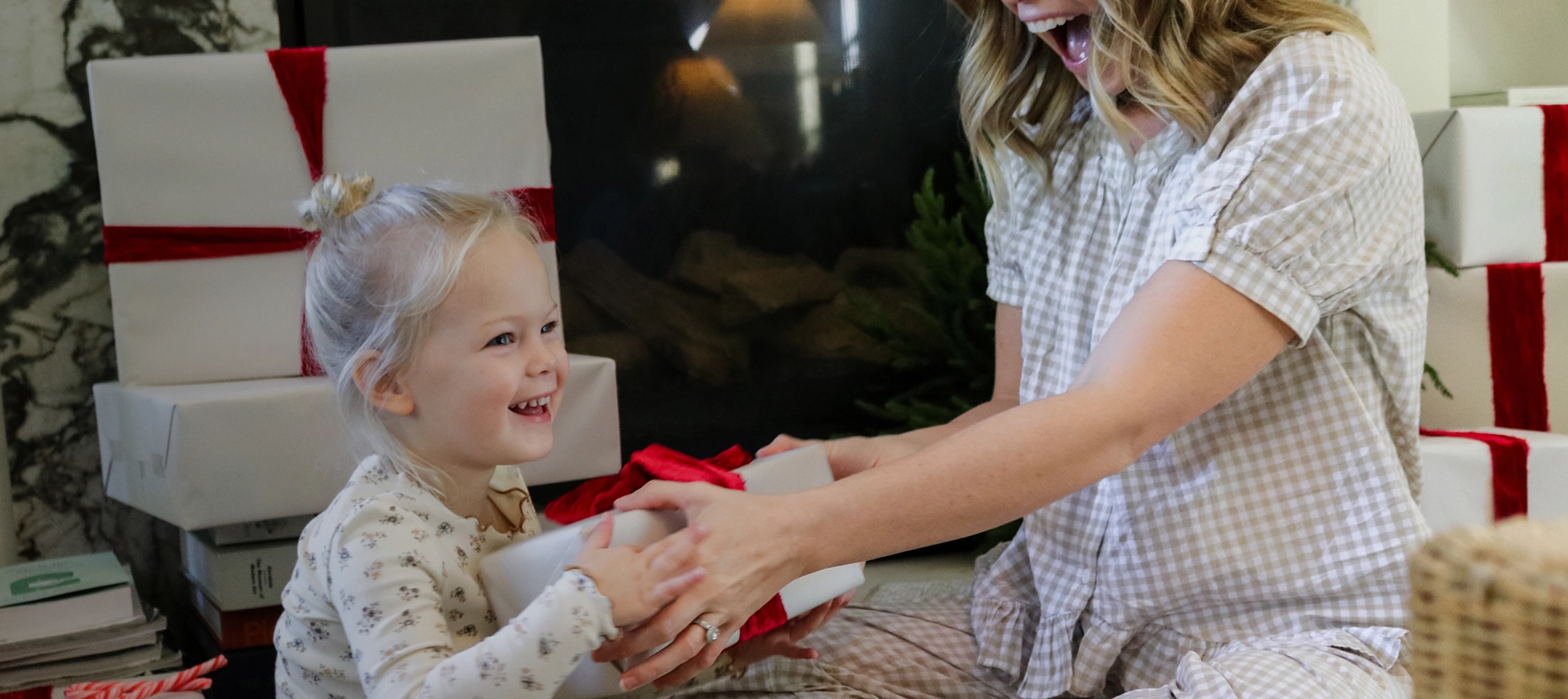Truly Free Laundry Wash and refill pouch in a laundry room, with a woman and baby in the background.