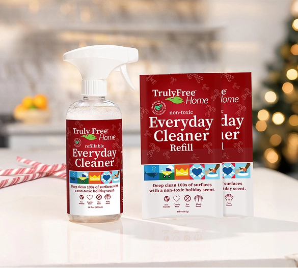 Truly Free Laundry Wash and refill pouch in a laundry room, with a woman and baby in the background.