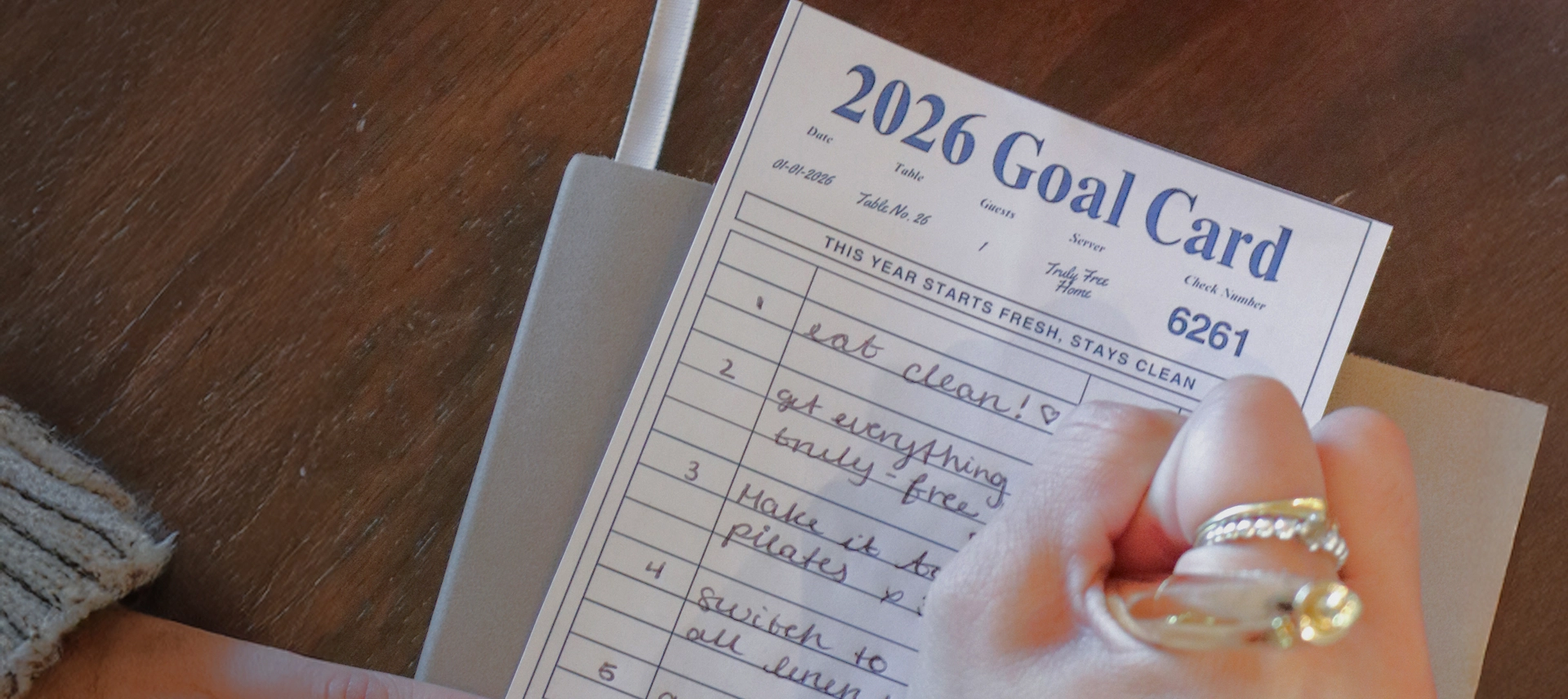 Truly Free Laundry Wash and refill pouch in a laundry room, with a woman and baby in the background.