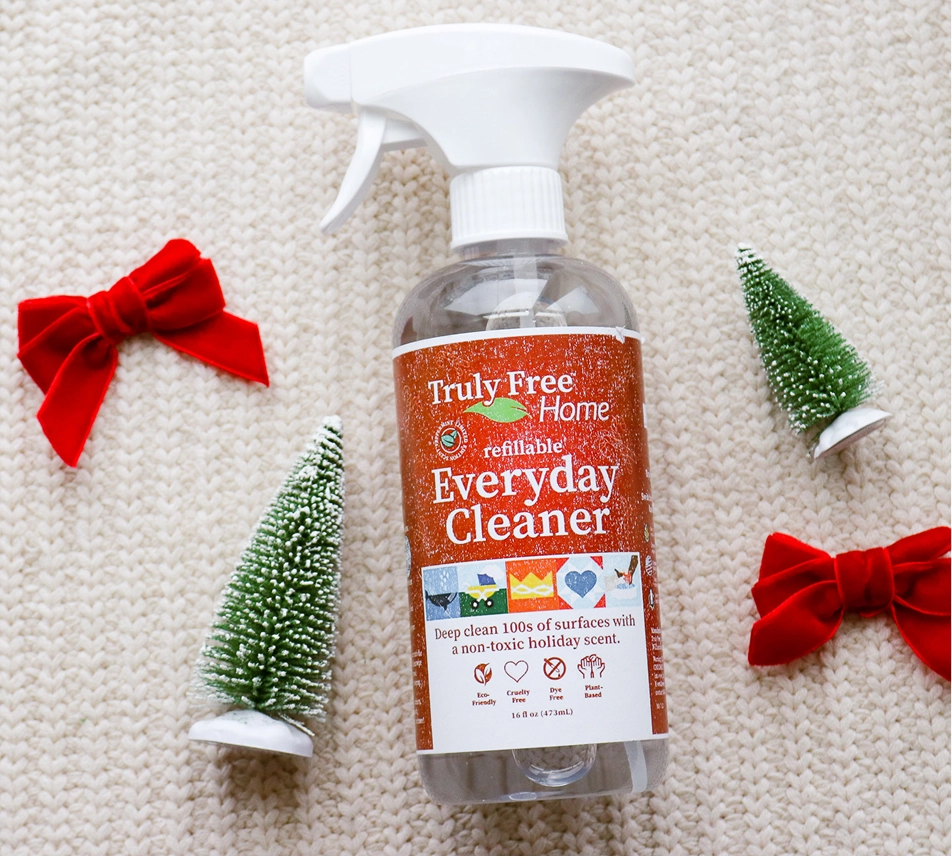 Truly Free Laundry Wash and refill pouch in a laundry room, with a woman and baby in the background.