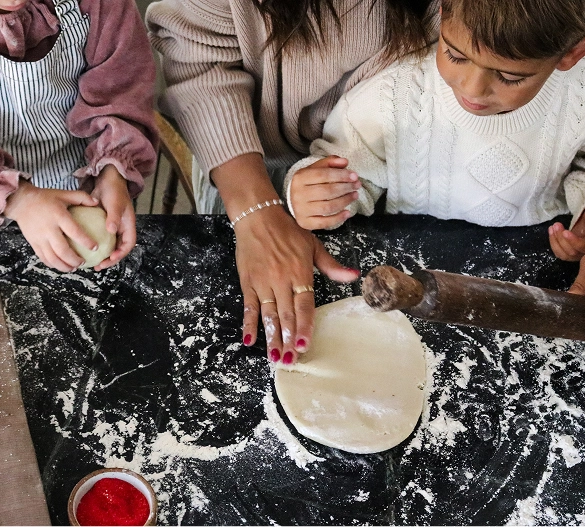 Truly Free Laundry Wash and refill pouch in a laundry room, with a woman and baby in the background.