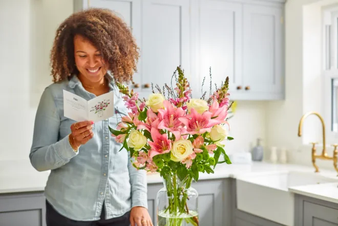 A mother reading a message in her card