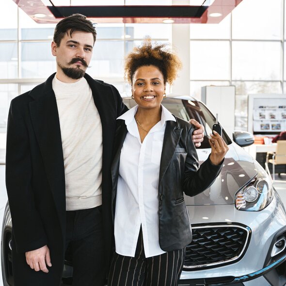 Couple test driving a car at a car dealership