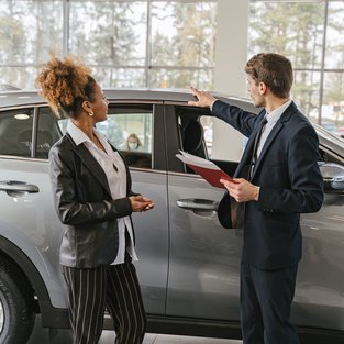 Car subscriptions vs car leasing woman and man car dealership