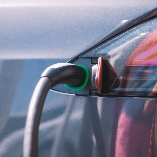 Electric vehicle plugged in at charging station