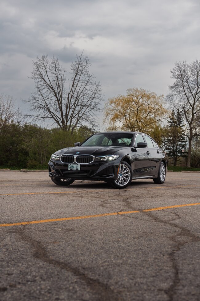 Black Polestar electric sedan from Roam in front of building