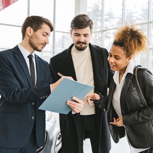 Car leasing couple at car dealership
