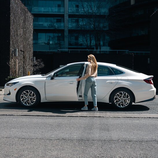 Car subscriptions vs car leasing woman at car dealership