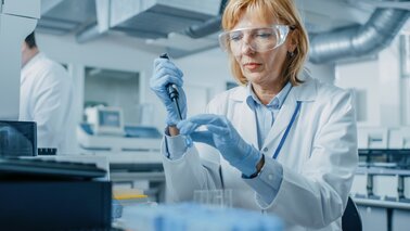 Image of a female scientist in a laboratory, preparing custom enzyme solutions with precision equipment