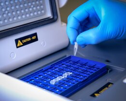 Illustration of a PCR machine in use, emphasizing its role in amplifying nucleic acids for enhanced detection sensitivity in diagnostic assays.