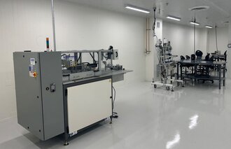 Photograph of dry room operation setup at Fortis manufacturing facility, featuring specialized equipment designed to maintain controlled humidity and temperature for sensitive materials.