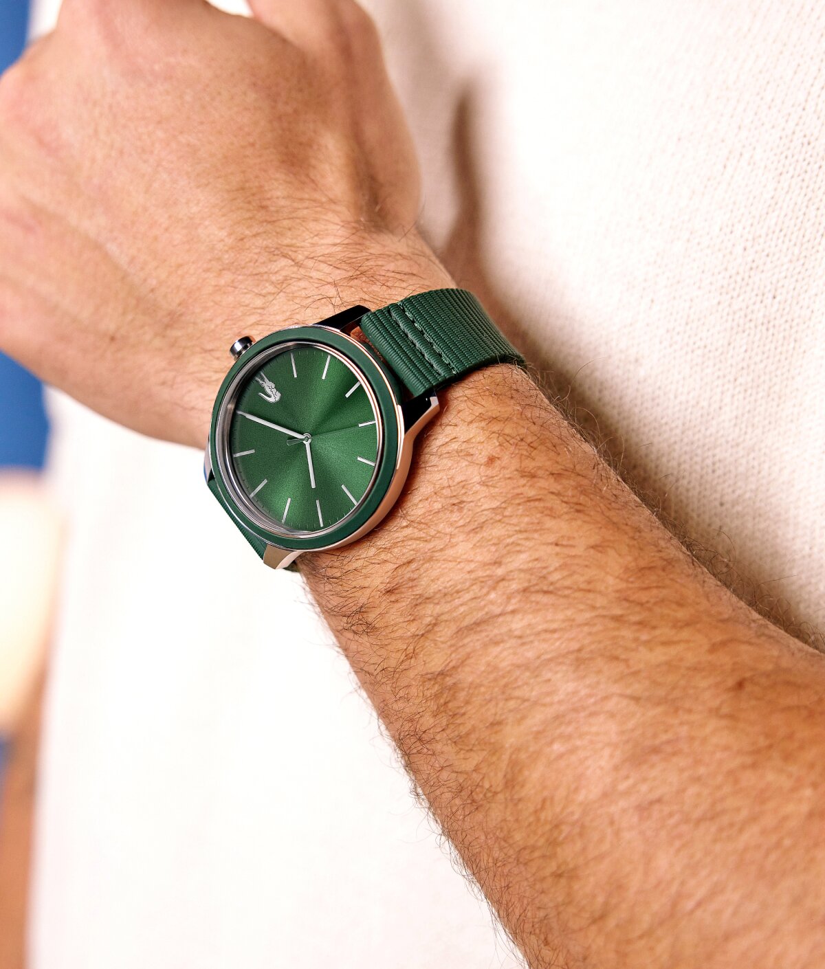 Model wearing Lacoste 12.12 watch with green strap and green dial