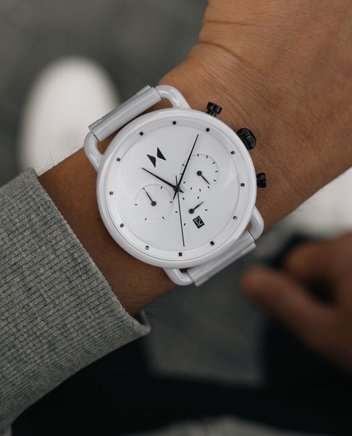 Model wearing MVMT Blacktop white ceramic watch showcasing timeless ceramic watches 