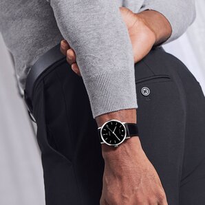 Movado Signature automatic watch on model with black strap, silver case and black dial 
