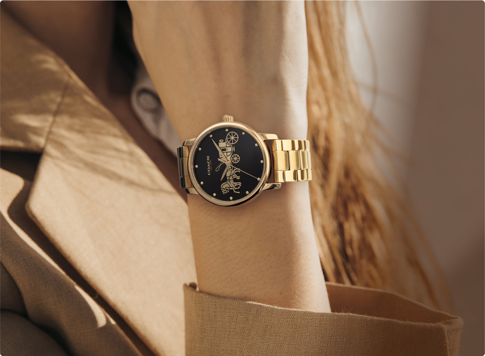 Coach Grand gold plated bracelet with black dial on model 