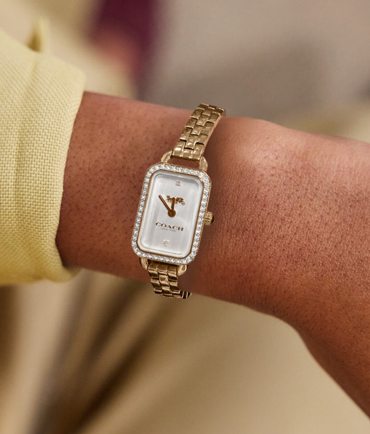 Coach Ludlow rectangle dial with gold plated bracelet on figure