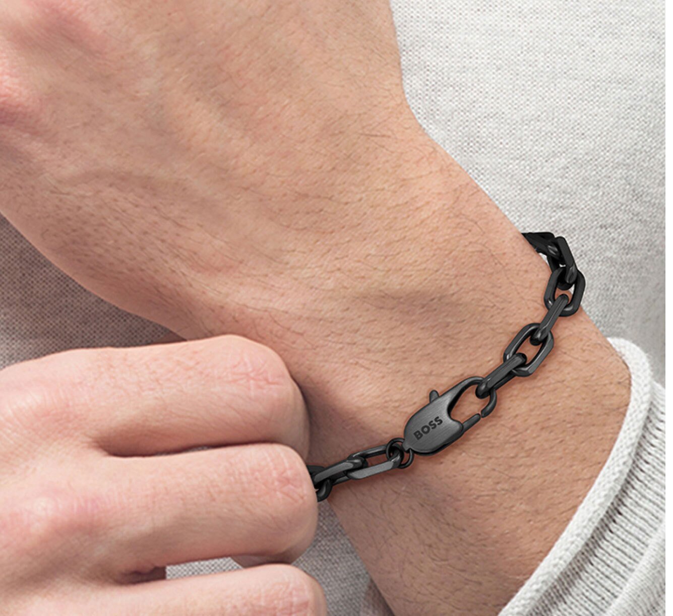 Model wearing men's Boss Kane bracelet composed of unique links