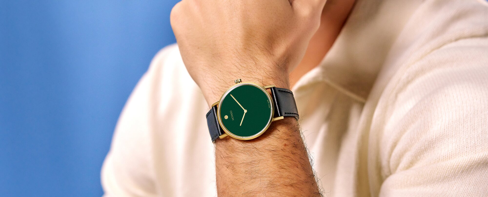 Model wearing movado signature watch with black strap and green dial on sale for $278