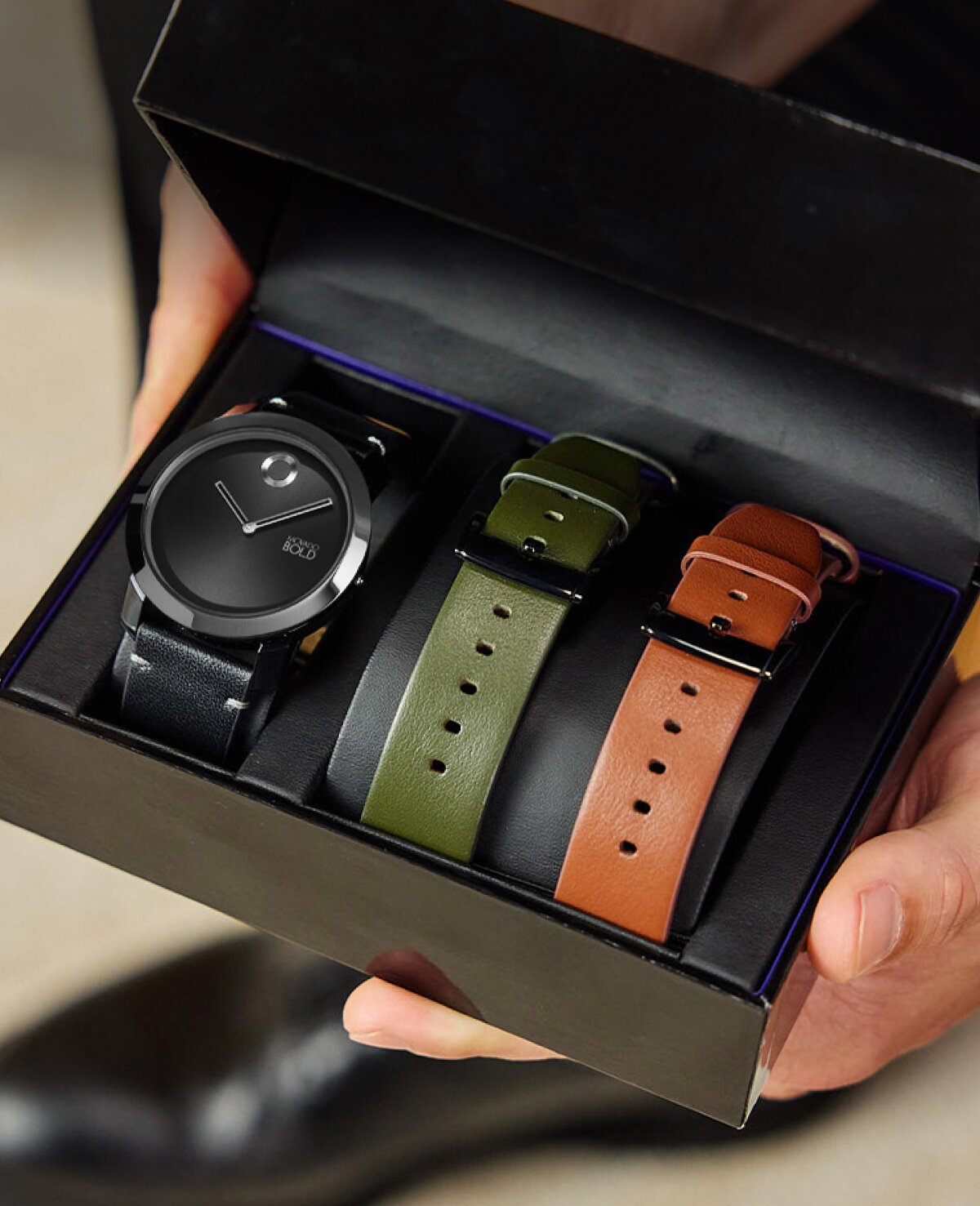 Model holding the Movado Trend Interchangeable gift set box with the opened