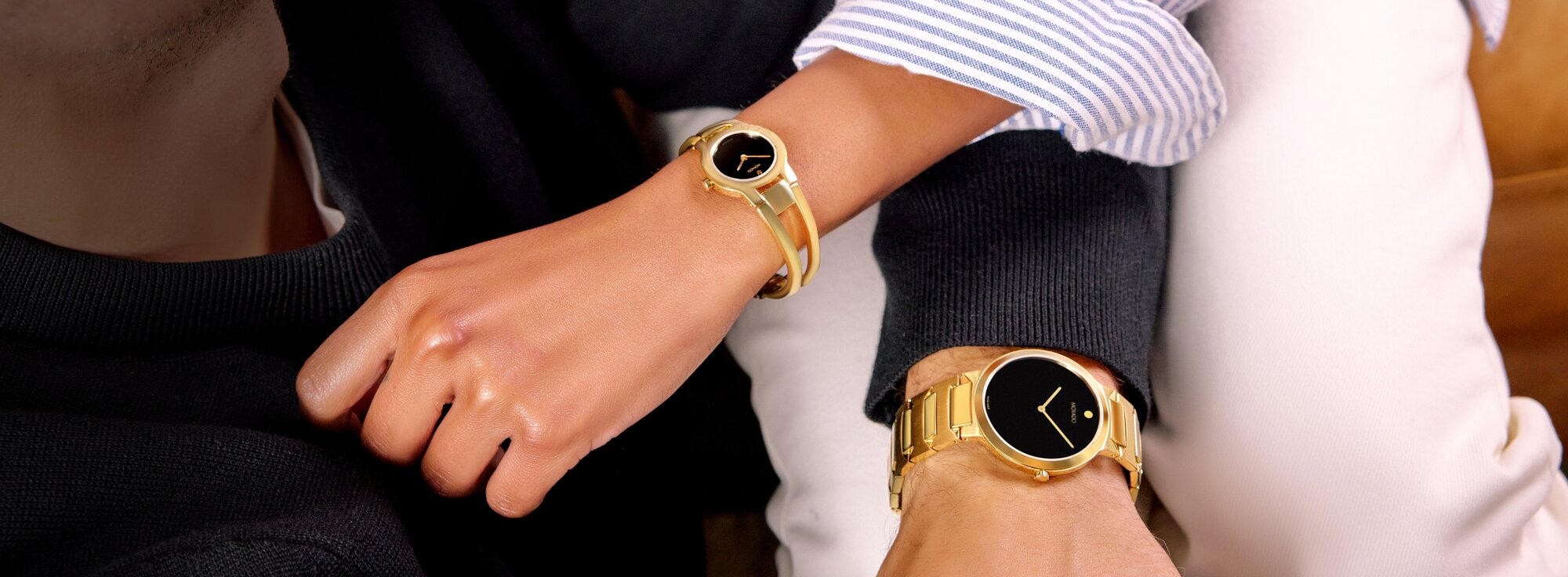 Movado temo gold bracelet with black dial on model paired with movado impresa with gold bracelet and black dial on model 