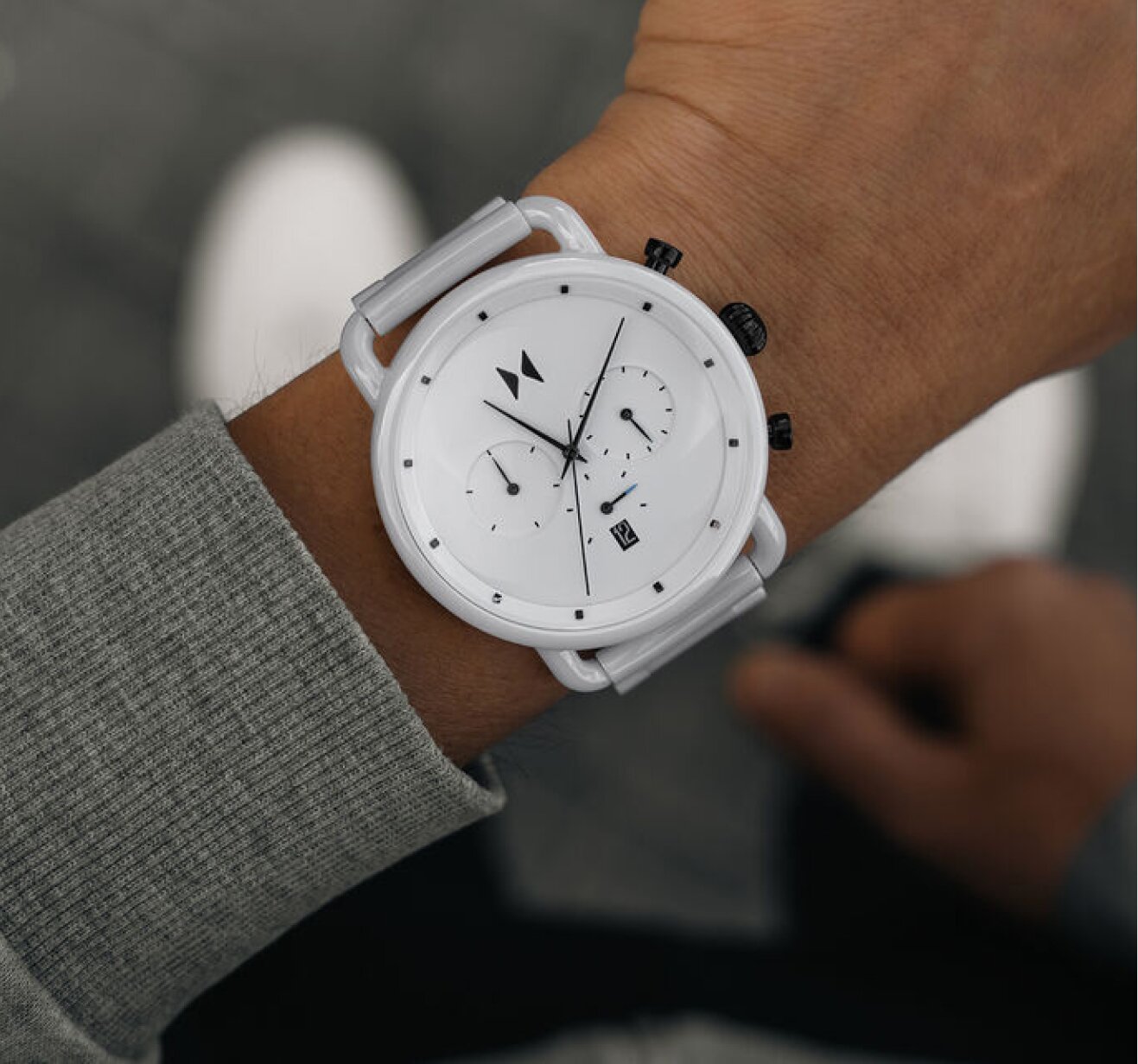 Model wearing MVMT Blacktop white ceramic watch showcasing timeless ceramic watches 