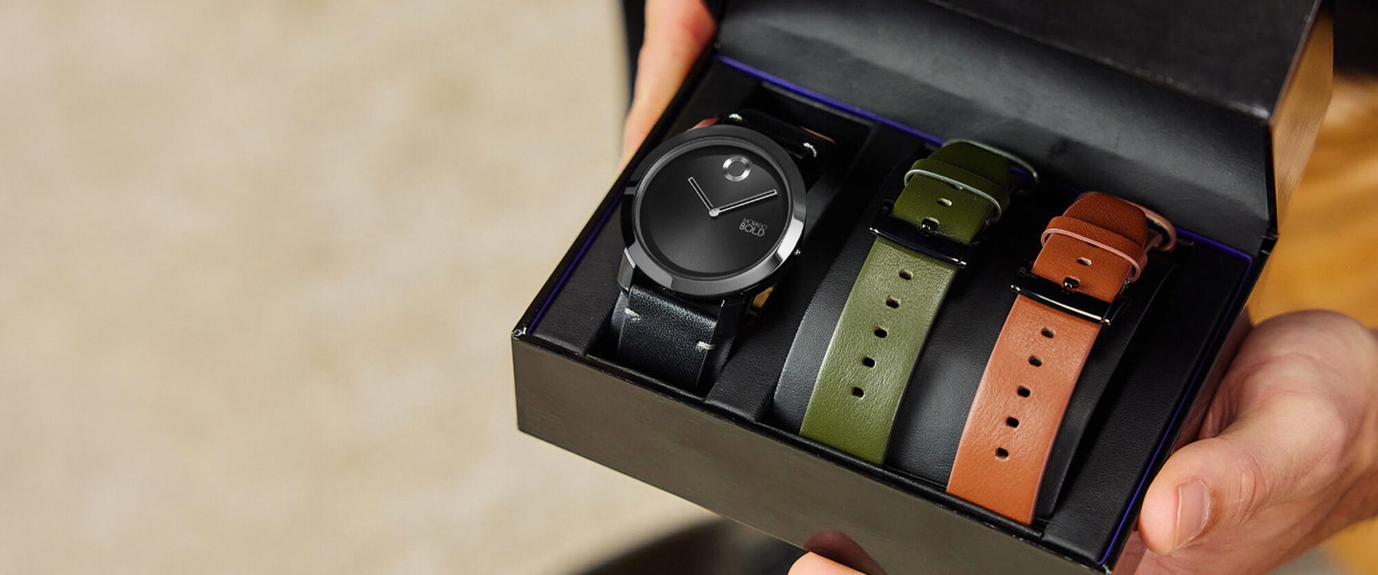 Model holding the Movado Trend Interchangeable gift set box with the opened