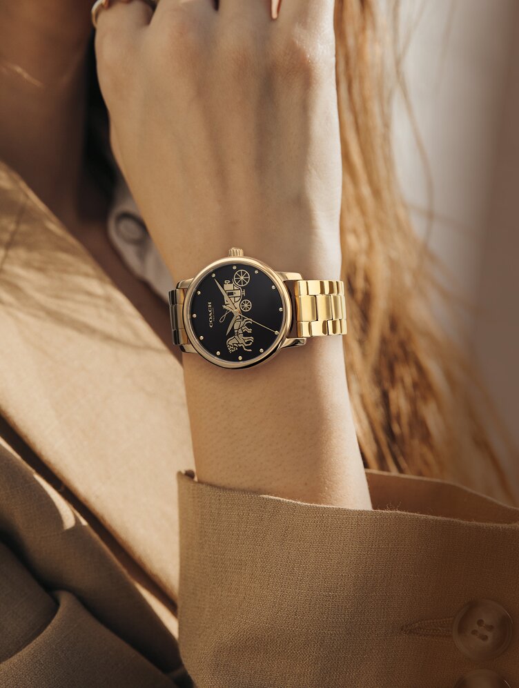 Coach Grand gold plated bracelet with black dial on model 