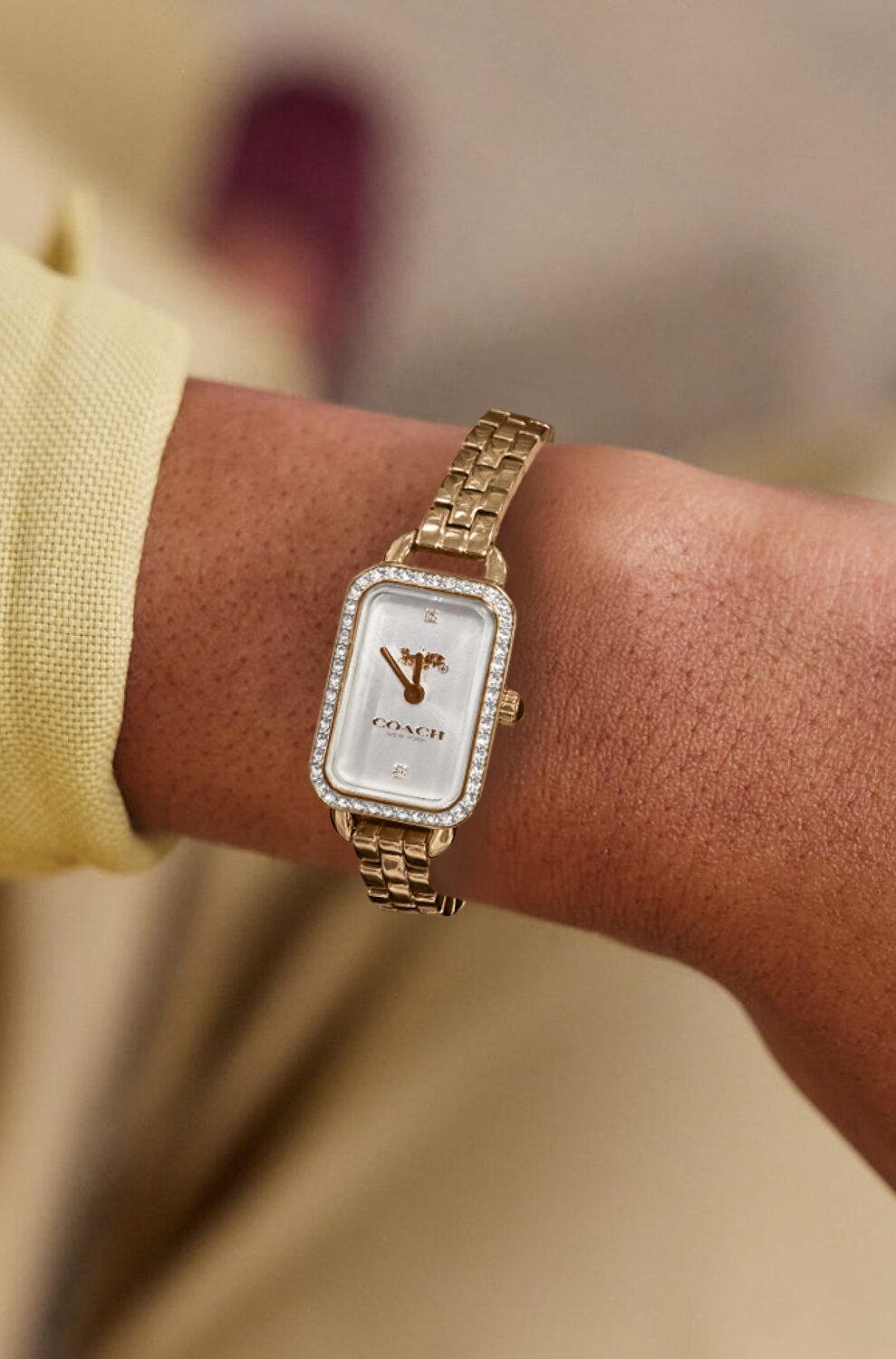Coach Ludlow rectangle dial with gold plated bracelet on figure