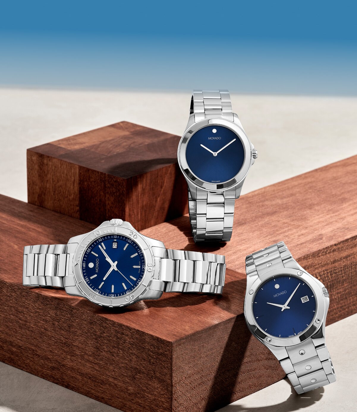 Movado Challenger, Movado Excel, and Movado Active sport watches with blue dials and silver bracelets
