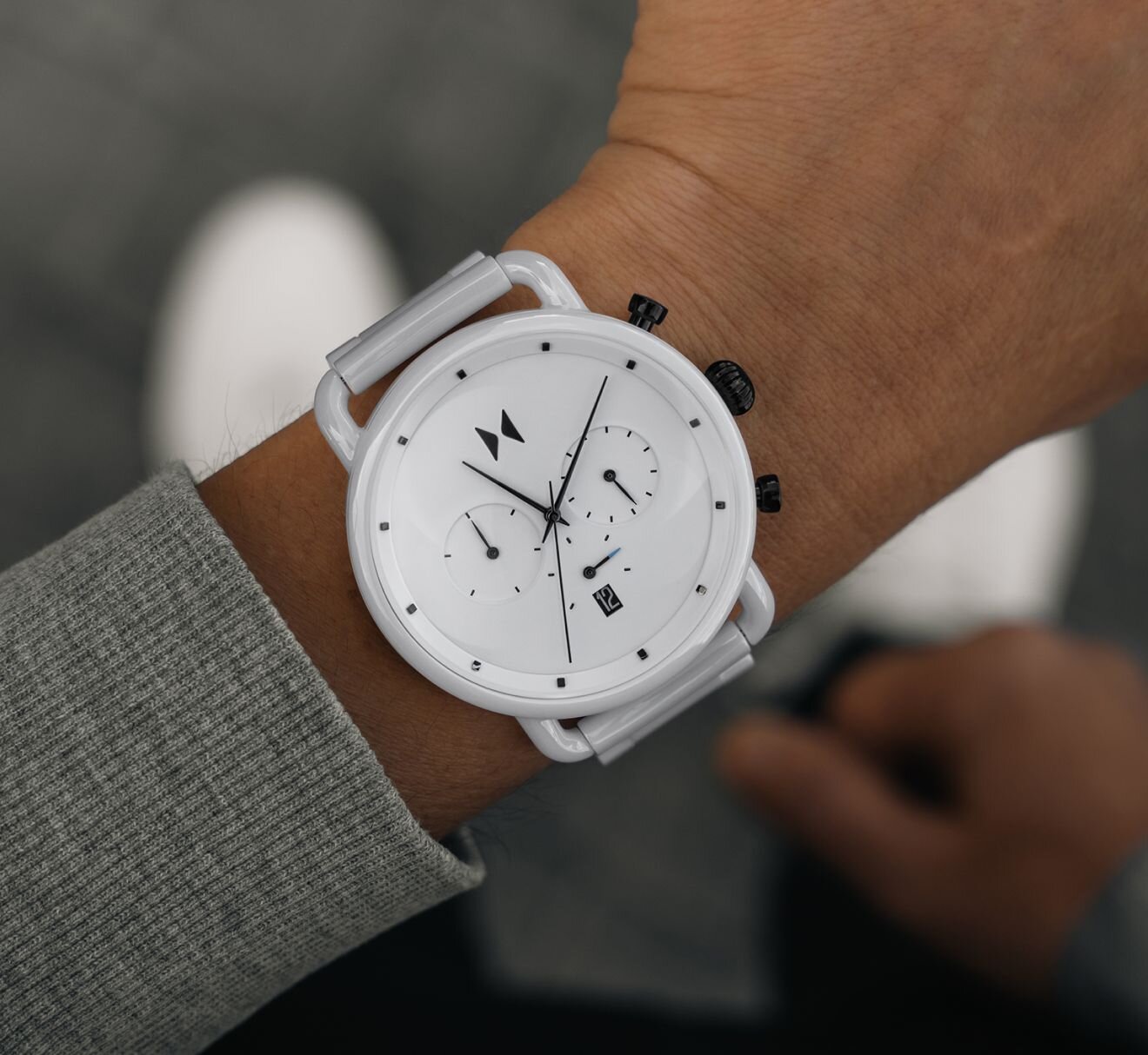 Model wearing men's MVMT Blacktop ceramic watch in white