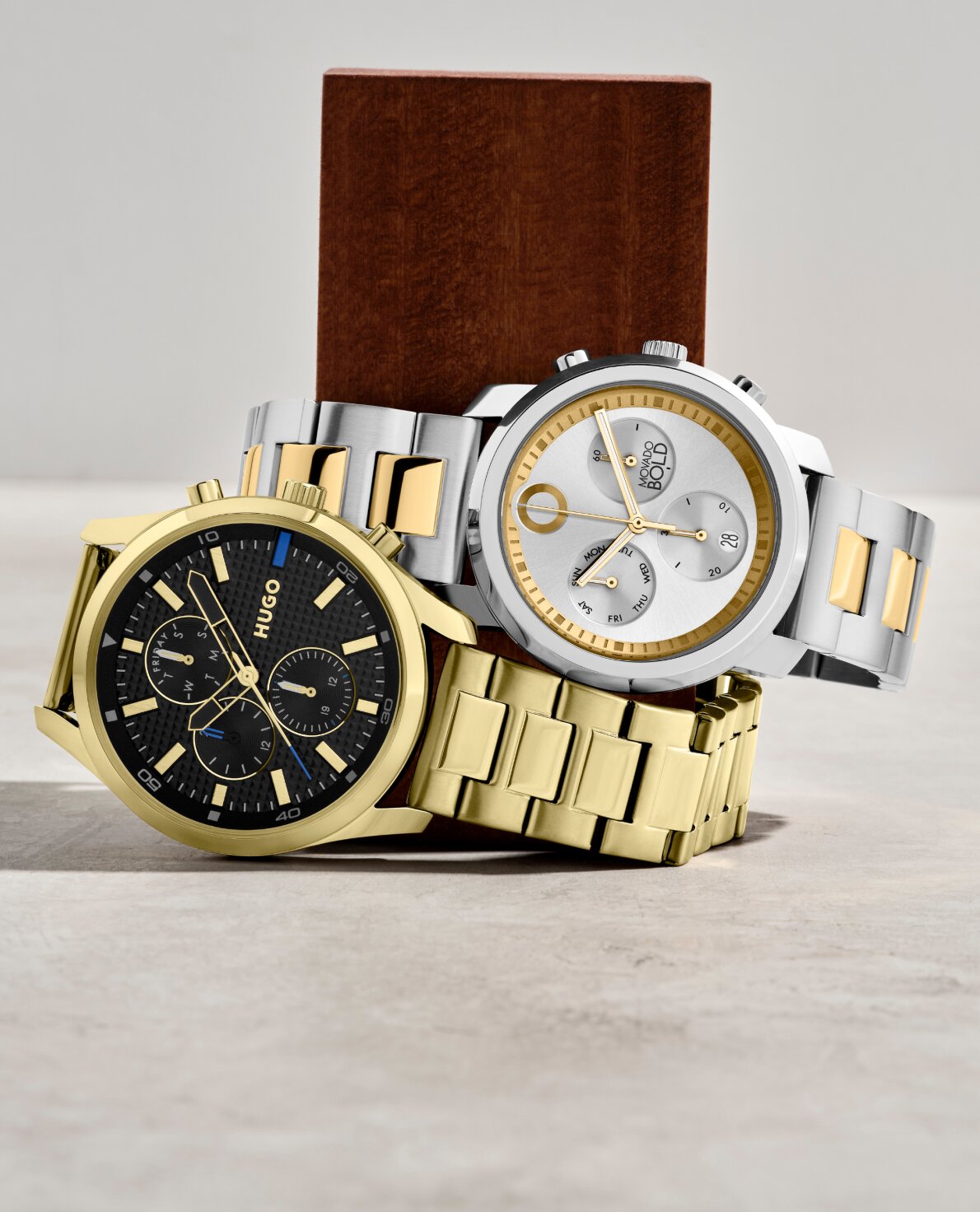 Movado Trend Propel watch with two tone bracelet stacked on top of Hugo #Chase gold bracelet showcasing sporty and stylish chronographs 