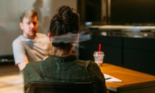 Two people at a table having coffee