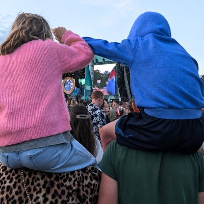 Family enjoying an outdoor concert together, celebrating everyday moments protected by Level Health health insurance Plan B.
