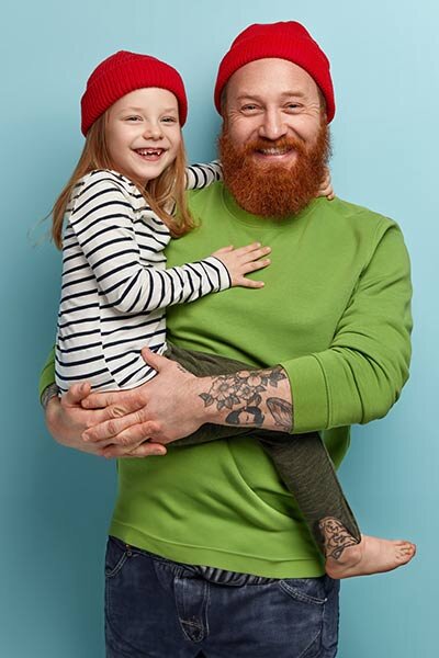 Our values - Dad holding young daughter.