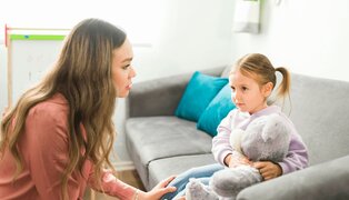 therapist talking to a child and using small talk discussion cards for kids