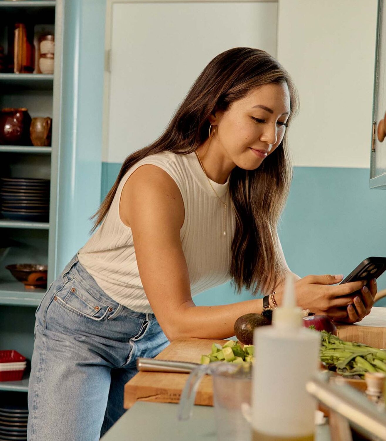 Clinician looking at mobile device in kitchen