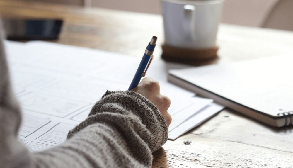 closeup of person writing on case conceptualization worksheet