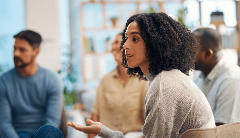 A female therapist asks “What is person-centered therapy?” and a colleague is about to explain person-centered therapy.