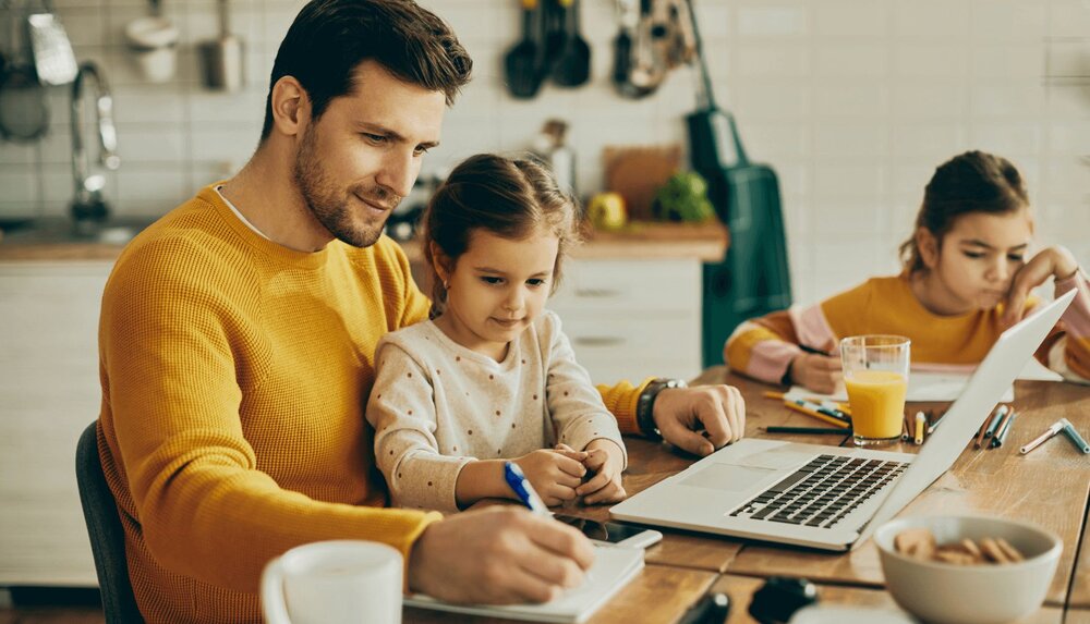 a father and his daughters working on a family roles worksheet
