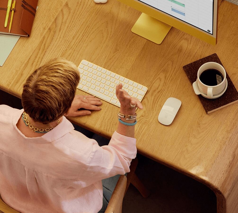 woman sitting at a desk on a telehealth call