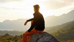 person looking out over nature to illustrate the looking back, looking forward exercise