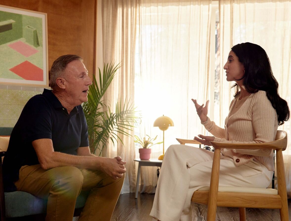 Practitioner talking with a client sitting on couch