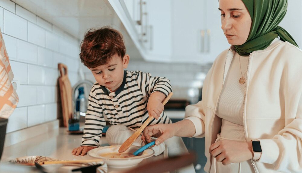 mother and son using parenting worksheet skills and cooking together
