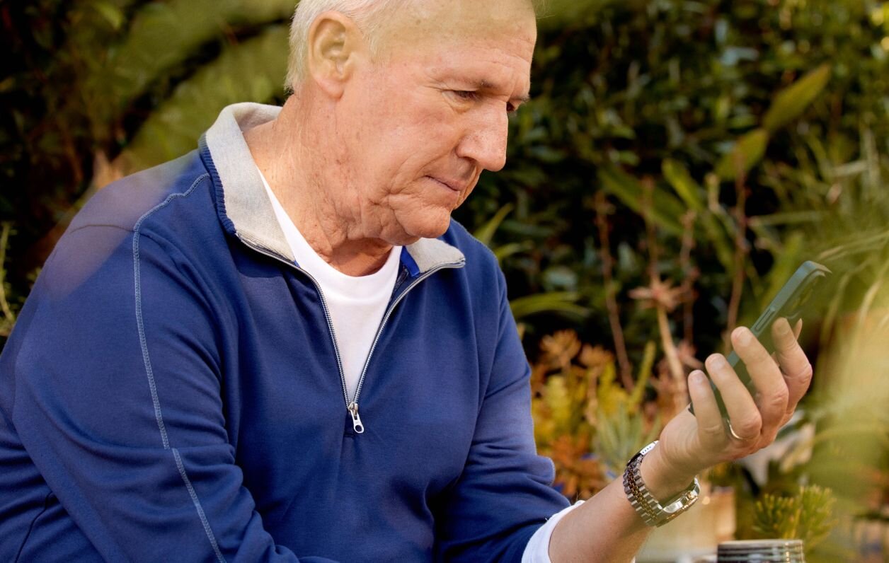 Man using mobile device to access Client Portal