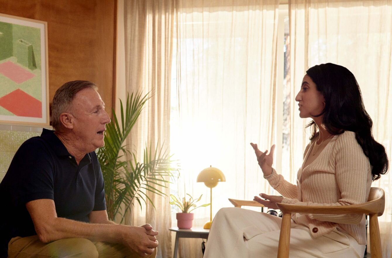 Practitioner talking with a client sitting on couch