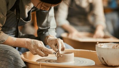 person engaging in pottery, an activity from their behavioral activation activities list