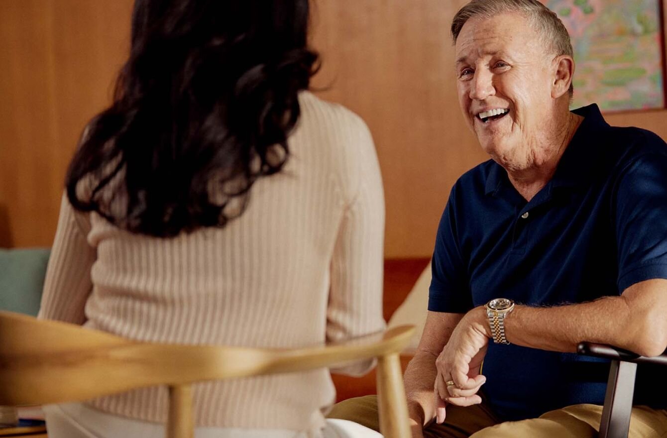 Older client in chair talking with practitioner